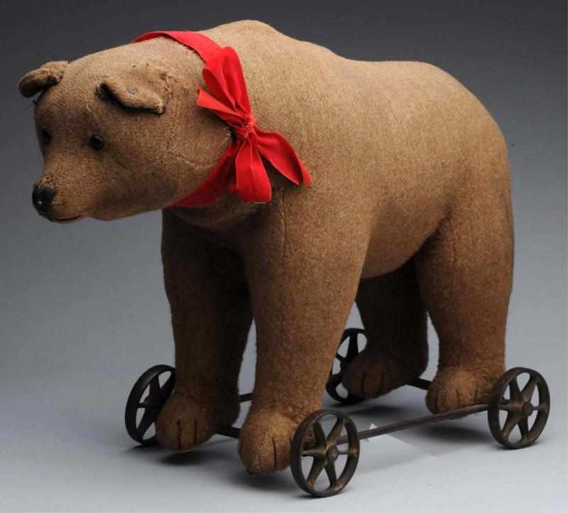 Appraisal: Early Steiff Bear on Wheels Brown mohair bear on metal