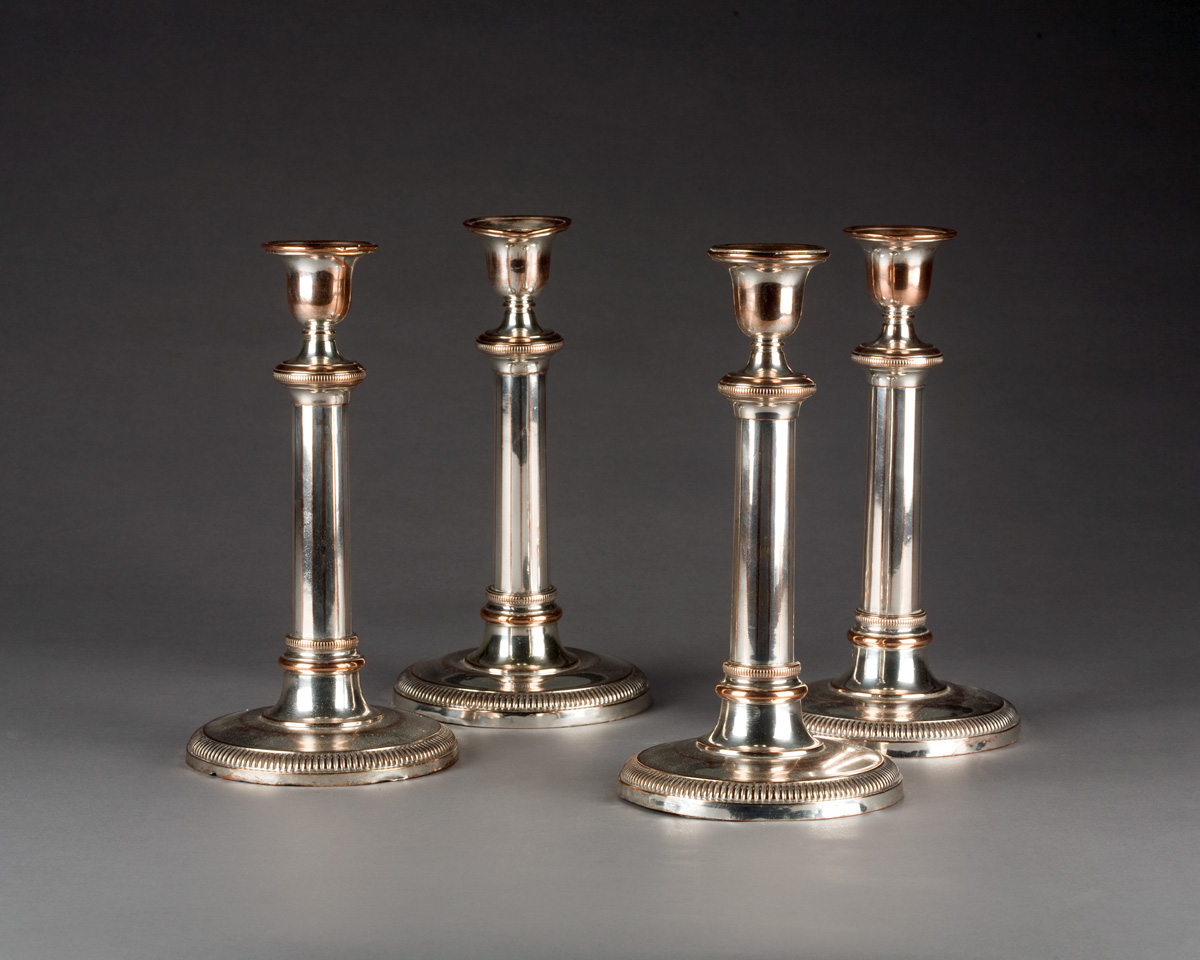 Appraisal: SET OF FOUR REGENCY STYLE SHEFFIELD PLATE CANDLESTICKS Each urn-form