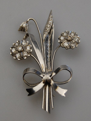 Appraisal: s platinum spray brooch having two diamond set flowers diamond