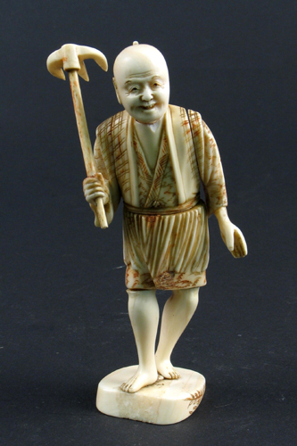 Appraisal: JAPANESE IVORY CARVED FIGURE depicting a barefoot man walking and