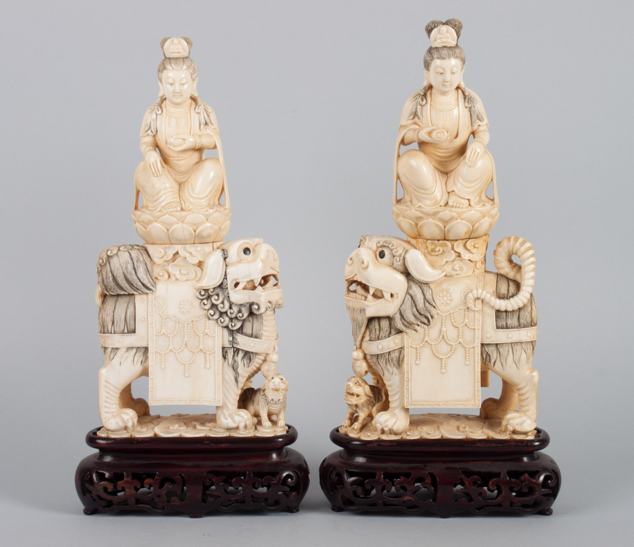 Appraisal: Pair of Chinese ivory mounted Quan-Yin groups modeled as goddess