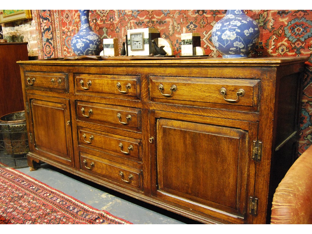 Appraisal: Oak low dresser with six drawers and two panelled doors