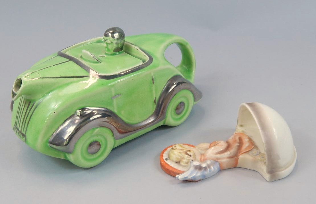 Appraisal: A mid thC Retro car teapot in green with silver