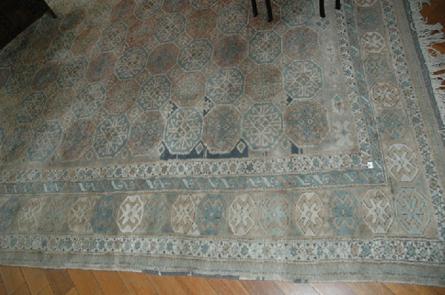 Appraisal: A PERSIAN FLOOR RUG With a repeating geometric pattern on