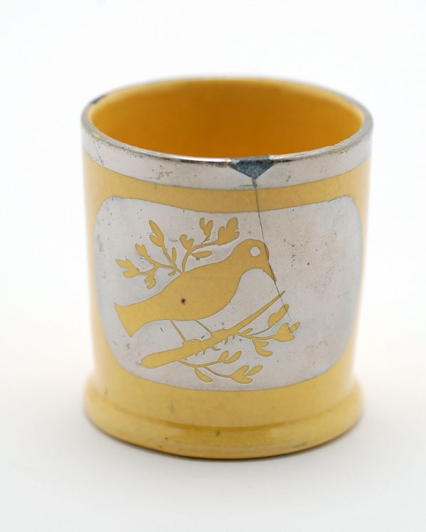 Appraisal: Child's canary cup with bird decoration in silver resist MEASUREMENTS