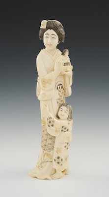 Appraisal: A Carved Ivory Figural of Mother Daughter A lovely woman