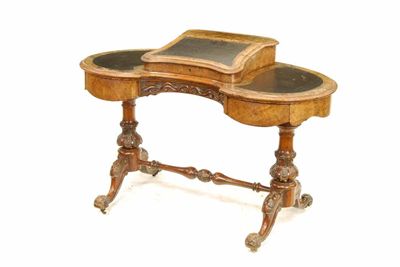 Appraisal: A Victorian walnut kidney shape desk the hinged slope to