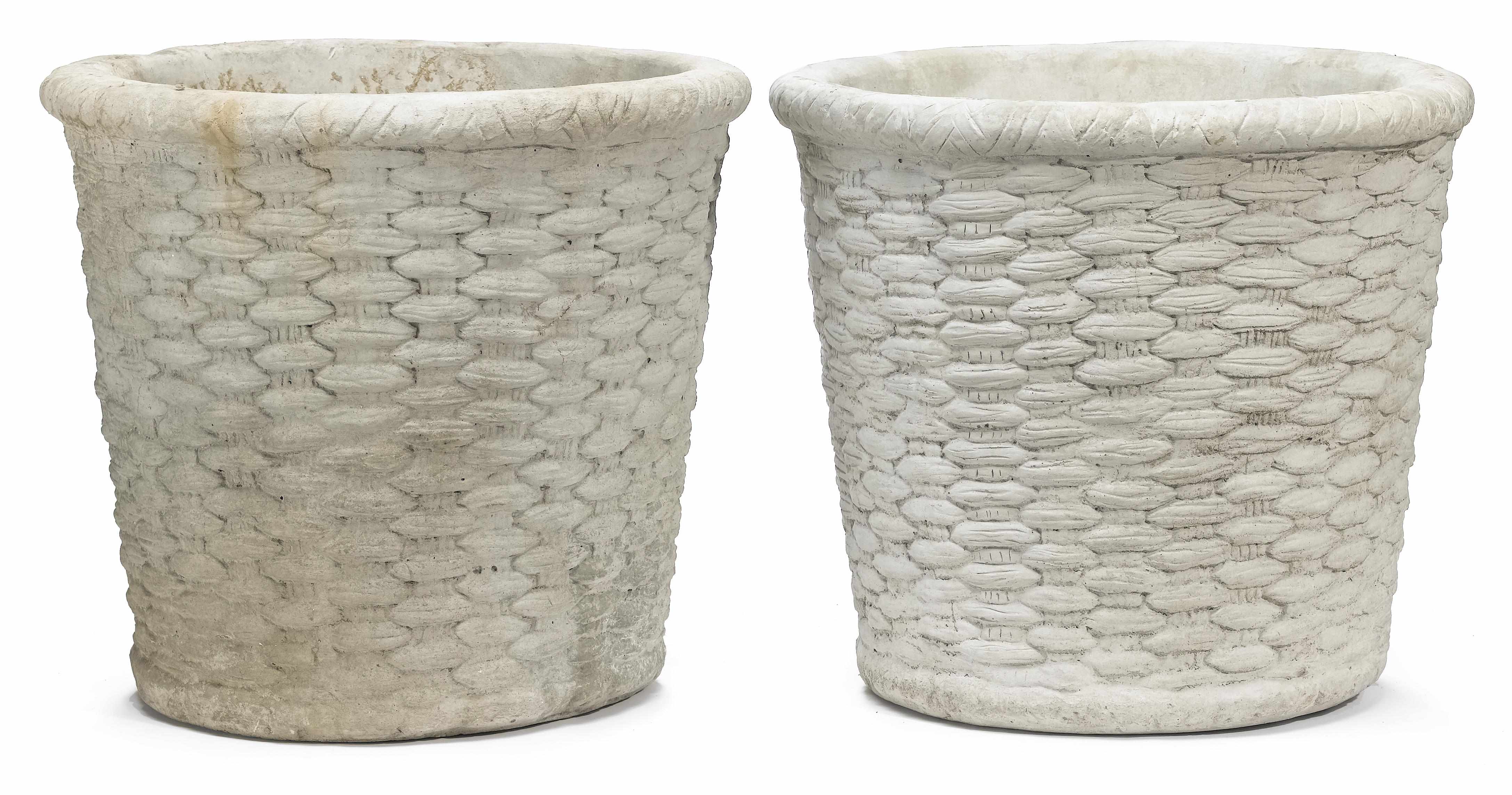 Appraisal: A pair of cast stone basket form jardinires second half