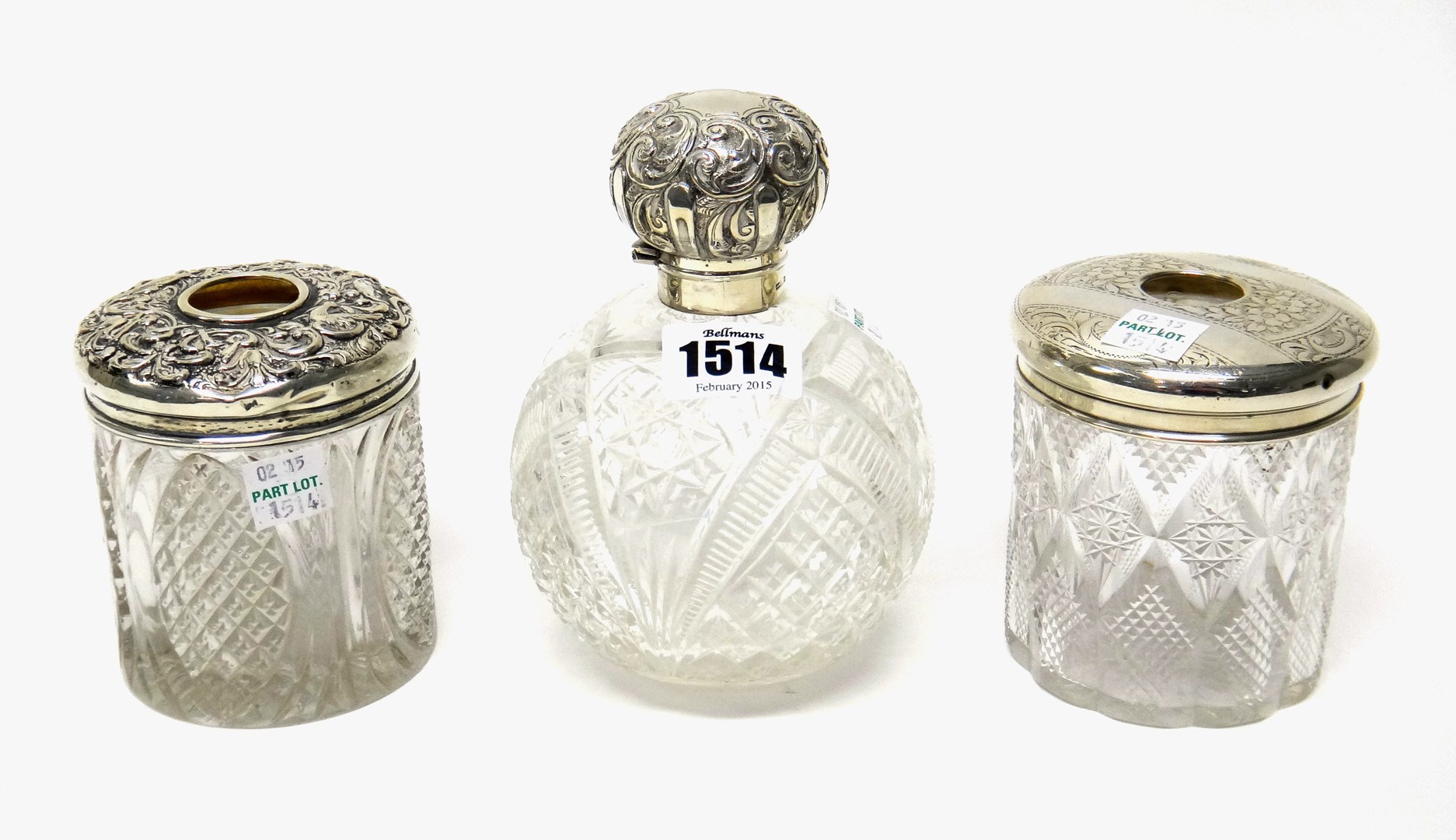 Appraisal: A silver topped faceted glass hinge lidded scent bottle with