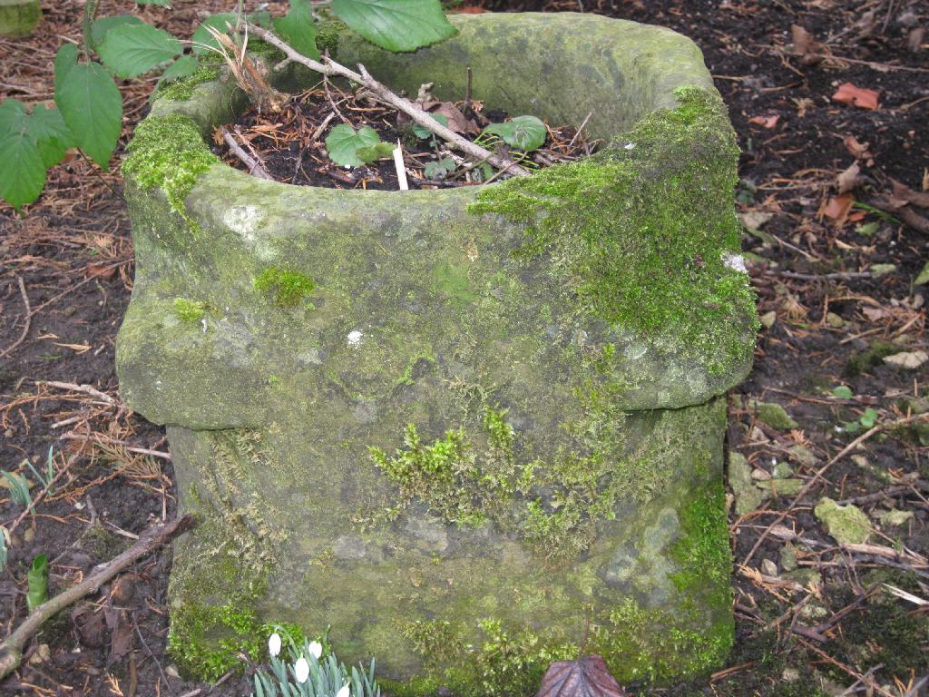 Appraisal: A square section stone Mortar with carved corner lugs circular