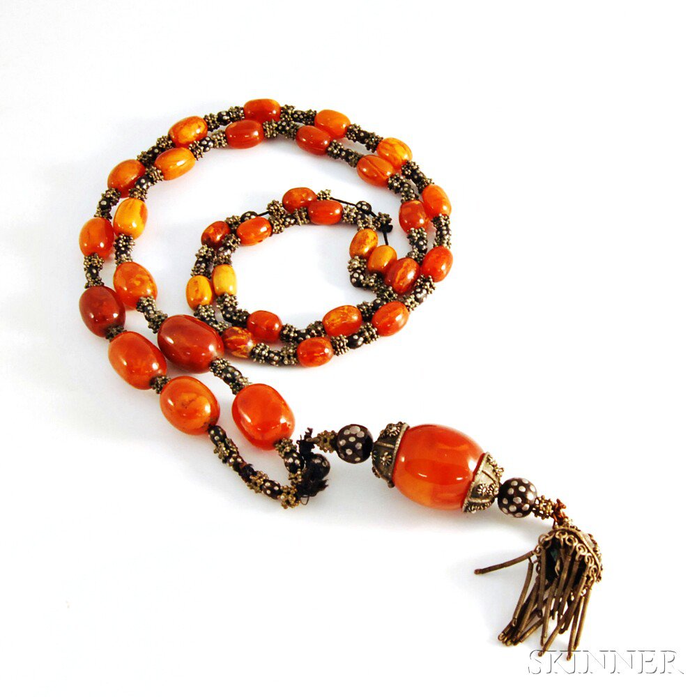 Appraisal: Amber Necklace comprised of graduated amber beads centering a larger