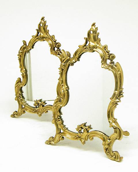 Appraisal: A pair Rococo style gilt bronze table mirrors early st