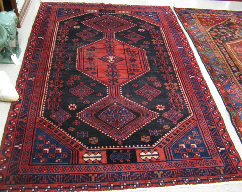 Appraisal: PERSIAN TRIBAL AREA RUG the dark blue field centering a