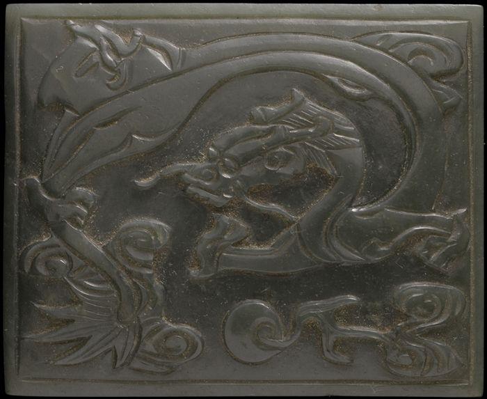 Appraisal: CHINESE CARVED GREEN JADE BUCKLE PLAQUE The rectangular surface with