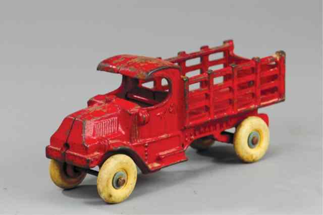 Appraisal: CHAMPION MACK STAKE TRUCK Cast iron painted in red overall