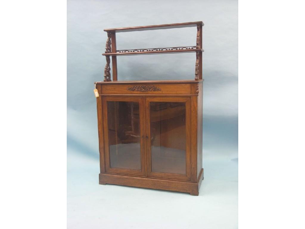 Appraisal: An early Victorian mahogany chiffonier twin-overshelves on carved leaf-scroll brackets