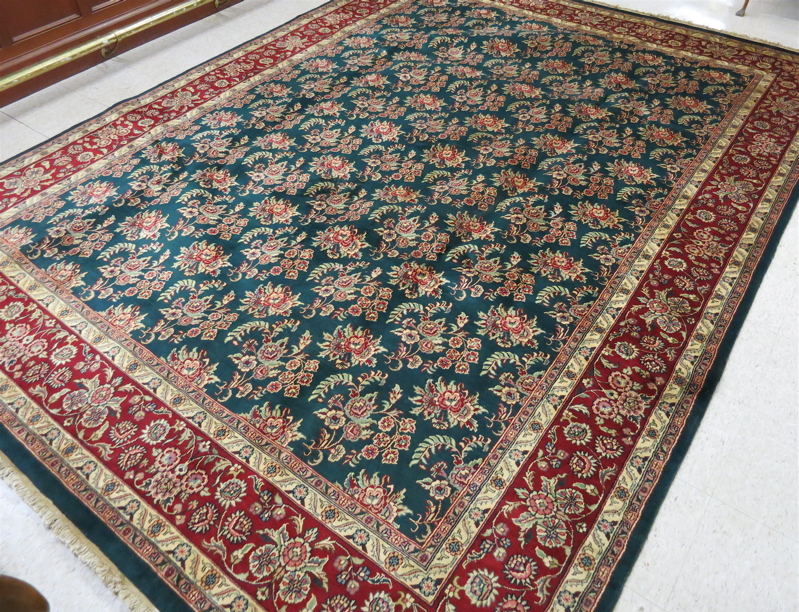 Appraisal: HAND KNOTTED ORIENTAL CARPET Indo-Sarouk featuring a green field covered