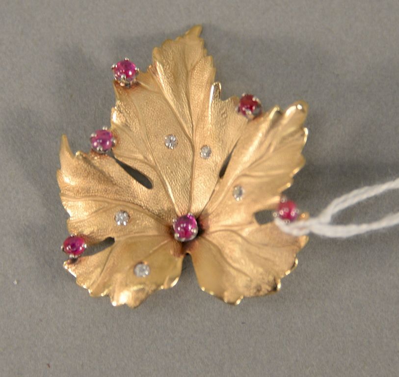 Appraisal: karat leaf pin set with six small red stone and