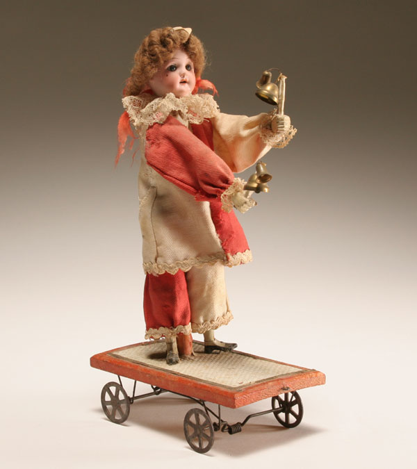 Appraisal: German bisque head jester mechanical pull toy doll raises arms