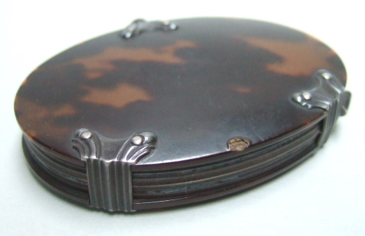 Appraisal: A silver mounted tortoiseshell oval magnifying glass the mounts with