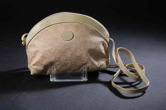 Appraisal: GUCCI CREAM CANVAS HANDBAG Demi-lune shape single compartment interior fitted