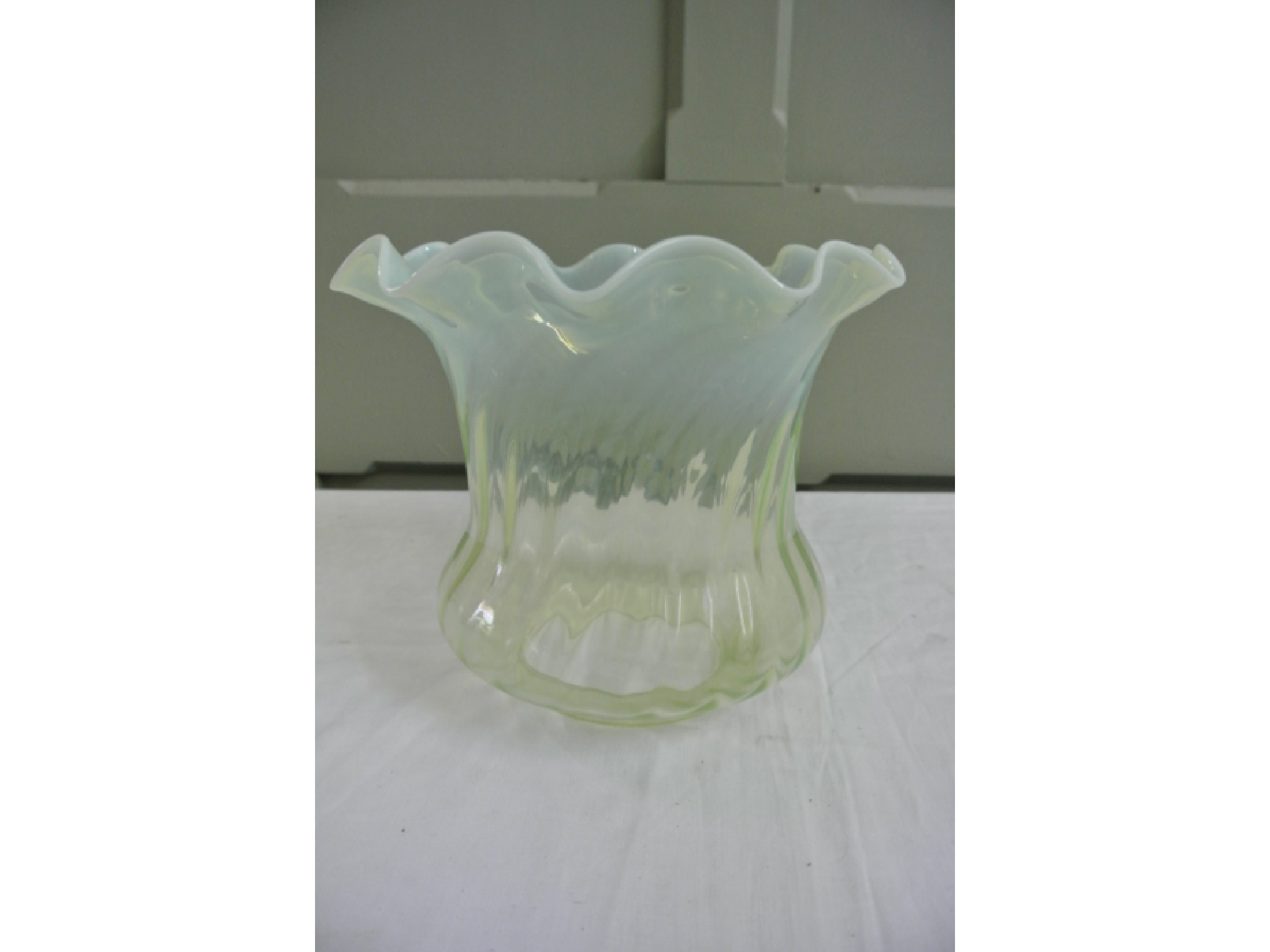 Appraisal: A reproduction Vaseline glass oil lamp wrythen moulded shade with