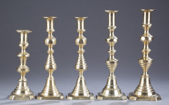 Appraisal: Assortment of Brass Candlesticks Varying heights with bee hive standards