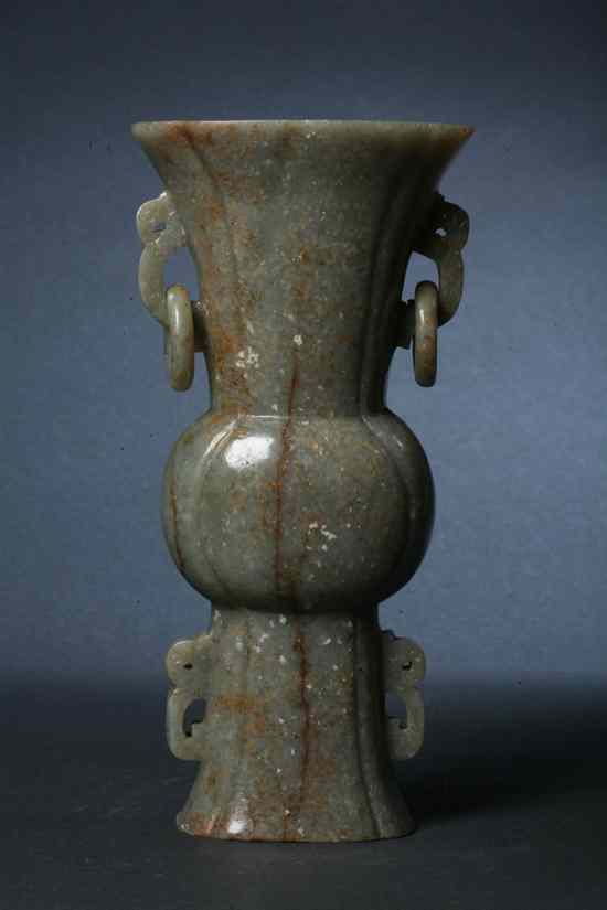 Appraisal: CHINESE JADE GU-FORM VASE Quatrefoil mouth and foot flanked by