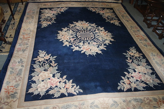 Appraisal: A CHINESE BLUE GROUND TRADITIONAL CARPET with foliate border approximately