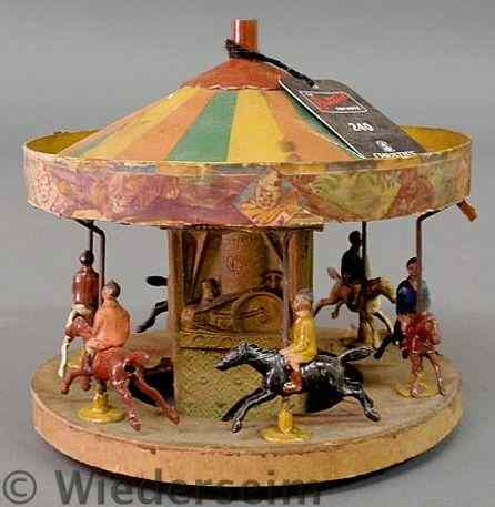 Appraisal: Brittains Round-A-Bout Circus with painted metal carousel horses and riders