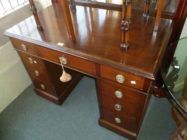 Appraisal: AN EDWARDIAN MAHOGANY PEDESTAL DESK of nine drawers with stylised