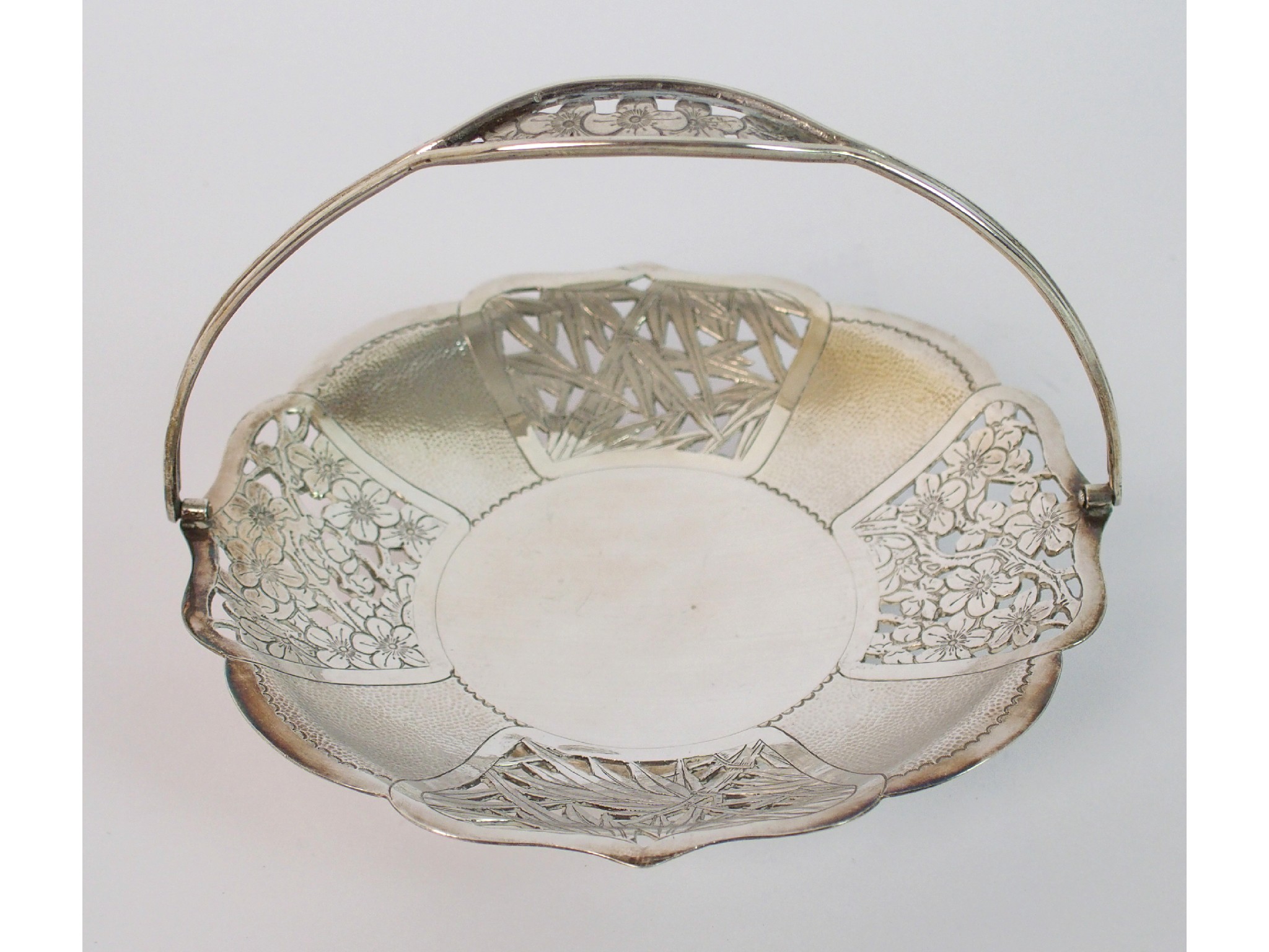 Appraisal: A Chinese silver pierced basketchased with panels of blossom and