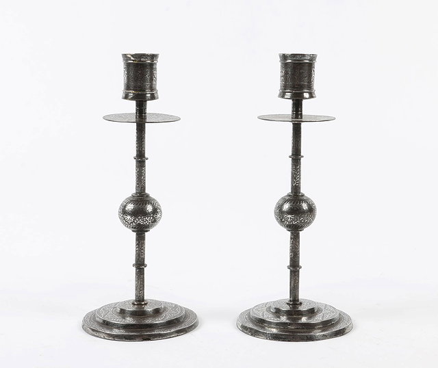 Appraisal: A PAIR OF CHINIOT PUNJAB KOFTGARI WORK CANDLESTICKS with waxed