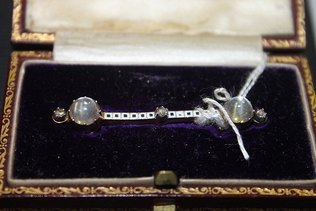 Appraisal: AN EDWARDIAN BAR BROOCH with enamel moon stone and diamond