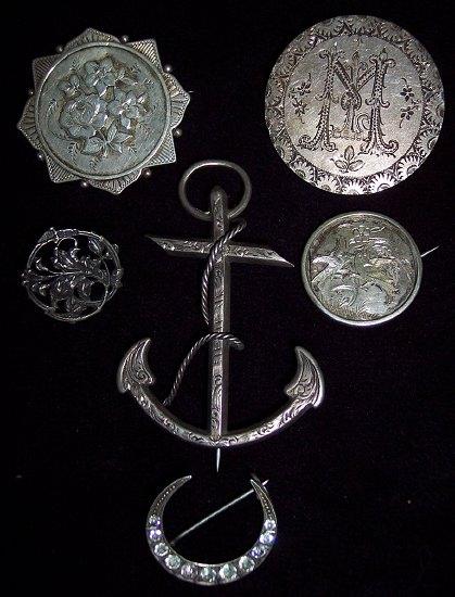 Appraisal: A silver anchor brooch engraved four other brooches and a