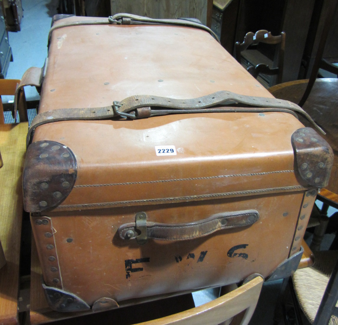 Appraisal: A brown leather trunk containing fabric