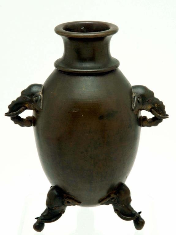 Appraisal: Egg-shaped Chinese cast bronze table vase with tusked elephant mounts