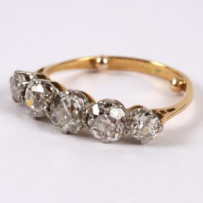 Appraisal: A diamond five-stone ring the graduated cushion-shaped stones claw set