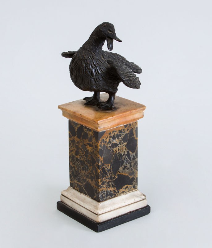 Appraisal: CONTINENTAL BRONZE FIGURE OF A DUCK ON VARIEGATED MARBLE PEDESTAL