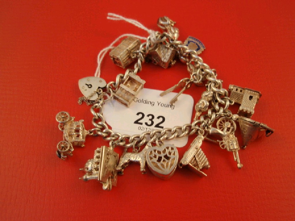 Appraisal: A silver charm bracelet with eighteen charms attached total weight