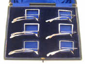 Appraisal: A boxed set of six silver wishbone menu holders Marks