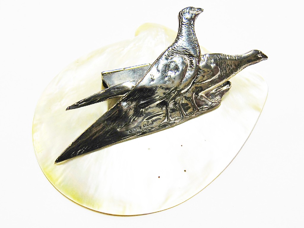 Appraisal: Ornamental Edwardian desk paperclip featuring two silver pheasants on mother-of-pearl