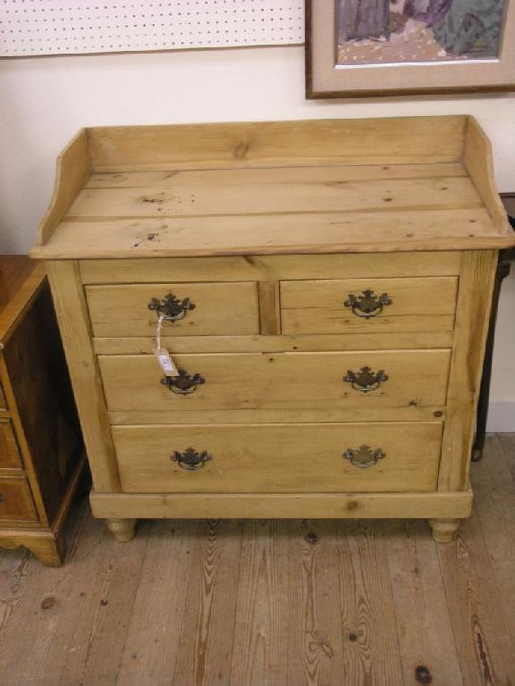 Appraisal: A late Victorian stripped pine chest with low raised back