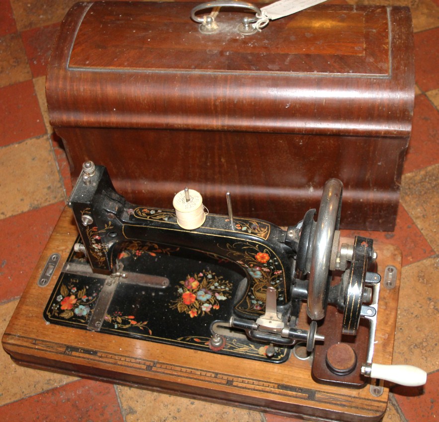 Appraisal: A Saxonia of Germany shuttle sewing machine with oak case