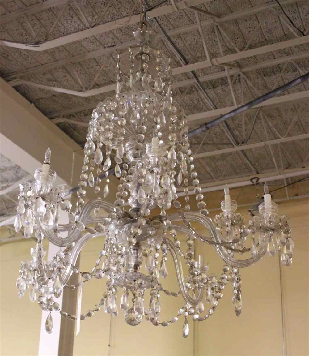 Appraisal: EIGHT LIGHT CRYSTAL CHANDELIER With scrolling arms and ovals drops