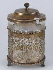 Appraisal: A pierced silver jam pot on three feet with loose