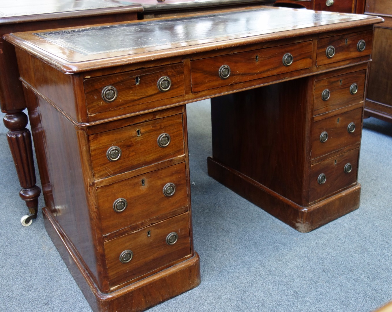 Appraisal: A Victorian walnut pedestal desk with nine drawers about the