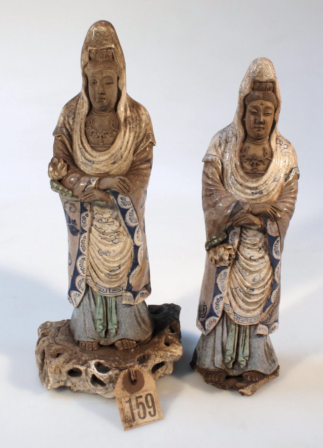 Appraisal: A near matching pair of part glazed terracotta figures of