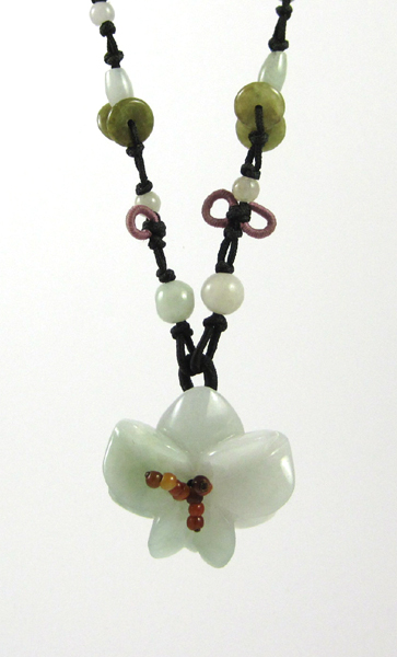 Appraisal: GREEN JADE NECKLACE suspended on an adjustable brown cord with