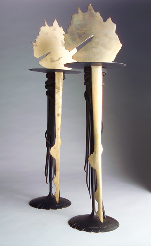 Appraisal: ALBERT PALEY Pair of Sunrise tall candlesticks of forged and